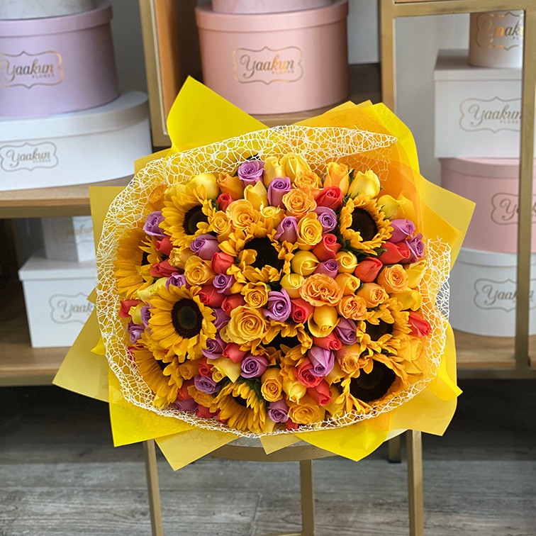 Maxi ramo de 100 y 10 girasoles rosas naranja, amarillo y lila con papel coreano y malla