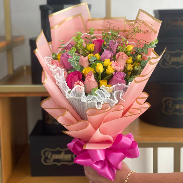 Bouquet con 12 rosas en tonos rosas y baby rose, follaje y malla