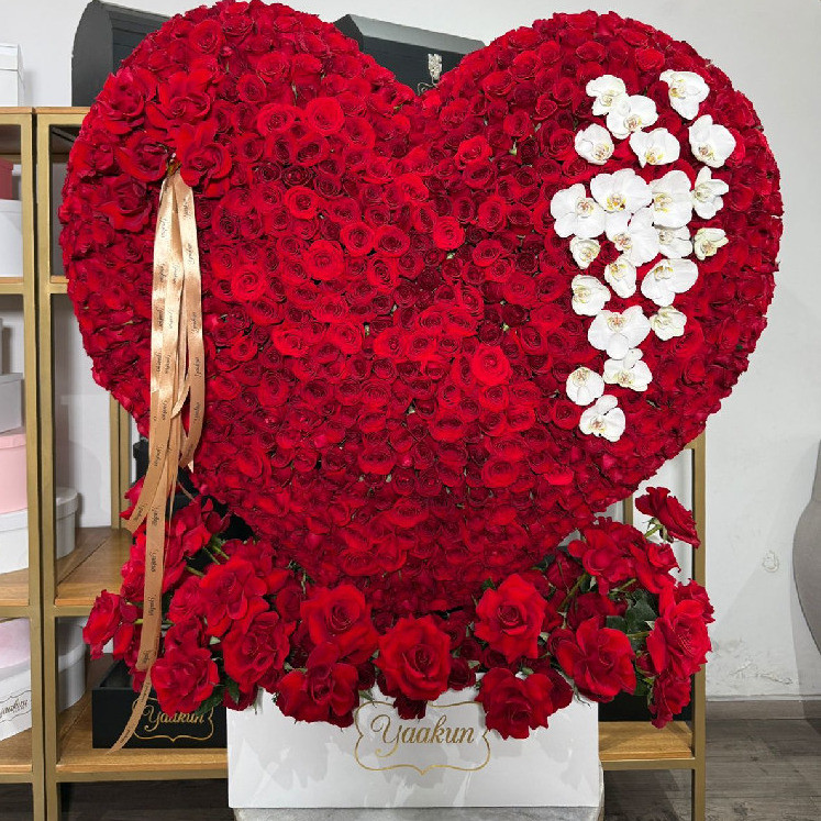 Escultura de corazón con 1200 rosas y toques de orquídea blanca en caja blanca